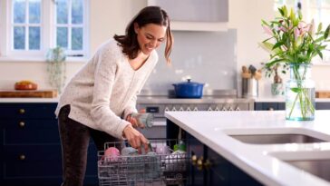 Woman loading her dishwasher