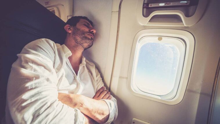Man sleeping on a plane