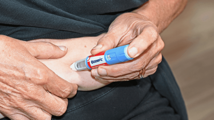 Women injecting herself in the stomach with an Ozempic semaglutide needle