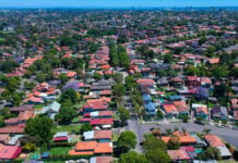 Panoramic Aerial Drone view of Suburban Sydney NSW Australia house, roof tops, the streets and trees