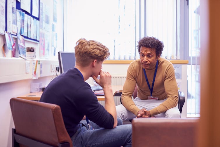 Man sits with social worker