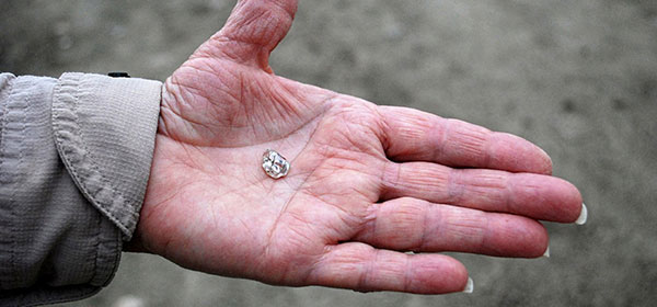 hand holding diamond found at the crater of diamonds state park