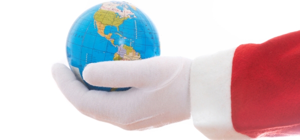 Santa's gloved hand holding a world globe