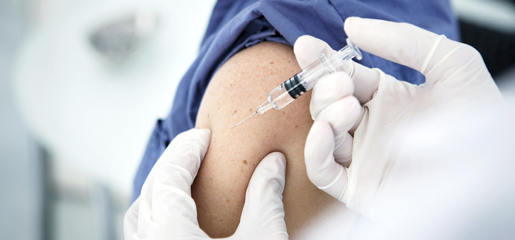 a woman receives a vaccination shot