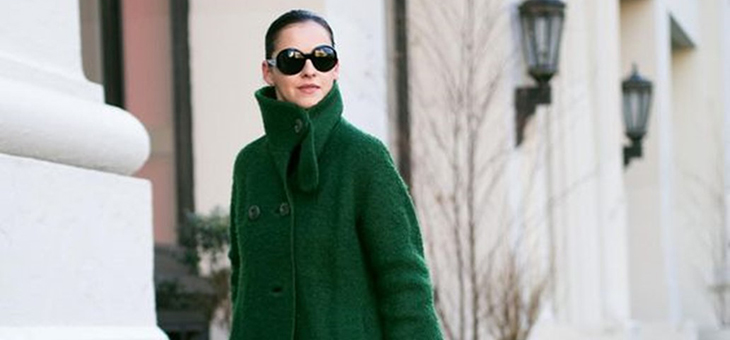 woman wearing sunglasses and a green coat