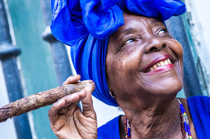 portrait of a beautiful cuban woman holding a cigar