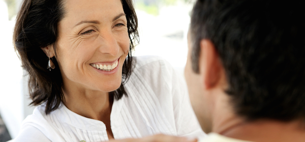 A smiling happy mature woman focusing her attention on her partner