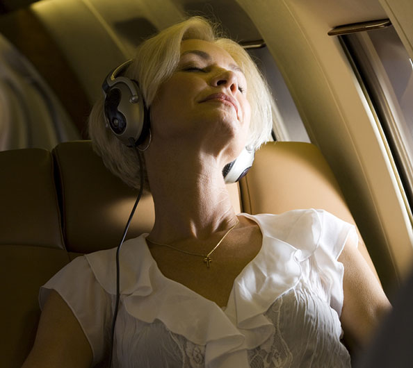 attractive middle aged woman sleeping on a plane