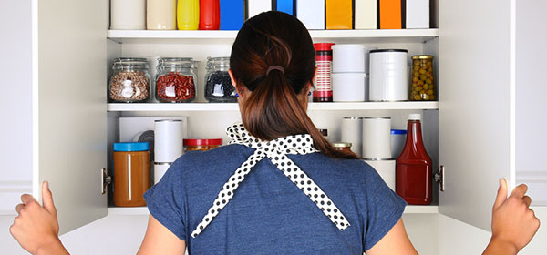 Back view of a woman looking in kitchen pantry