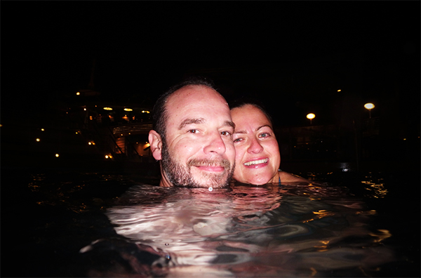 couple in the pool of a cruise ship under a starry sky