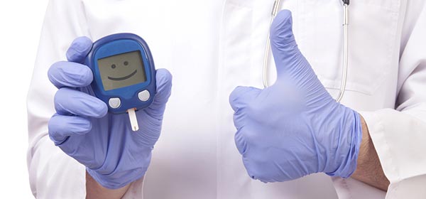 Doctors hands holding smiling diabetes reader