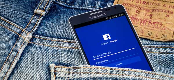 Facebook app on phone in back jeans pocket