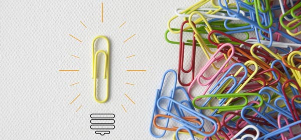 Group of paperclips with one individual paperclip apart