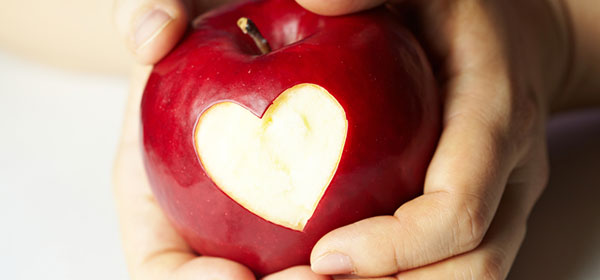 hands holding red apple bowel cancer