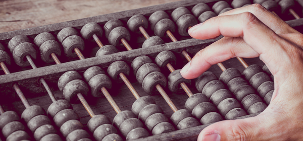 man calculating budget on an abacus