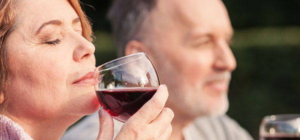 Mature woman and husband enjoying wine but risking immune system
