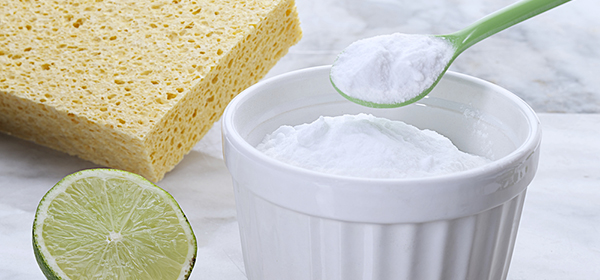 Natural kitchen cleaning products, lime, baking soda and sponge