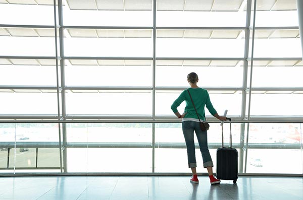 older female traveller waits for her plane