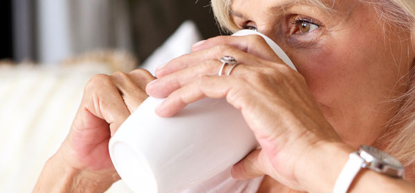 older woman drinking tea or coffee