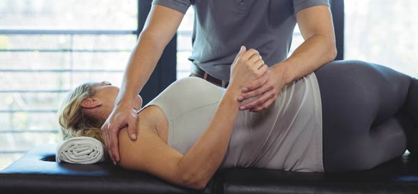 Physio treating woman for core strength Original