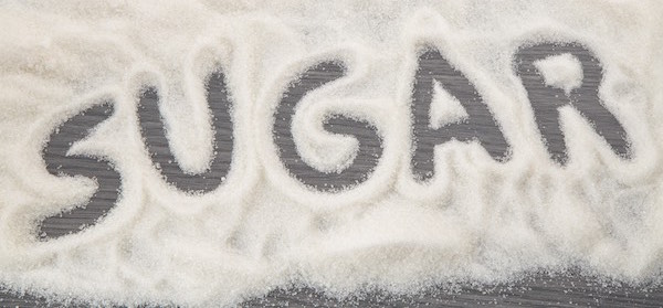 Pile of white sugar spelling out the word sugar are you addicted to sugar