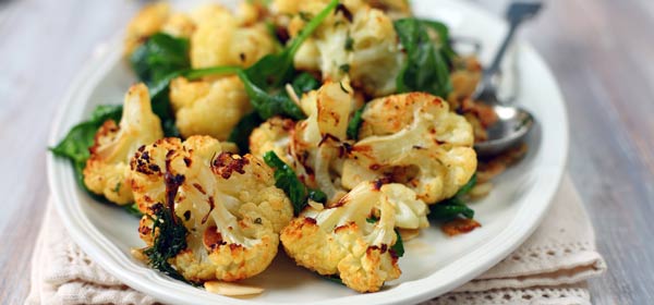 Plate of roasted cauliflower with spinach