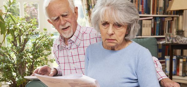 Retired couple look over their retirement finances with concern for risk
