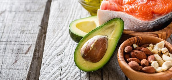 Selection of healthy fat foods including salmon and avocado
