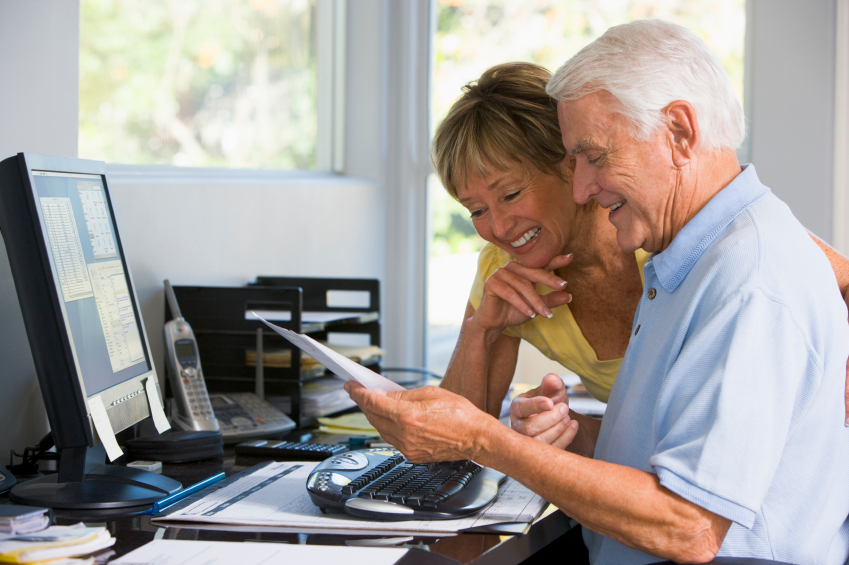 couple looking at finances in front of computer