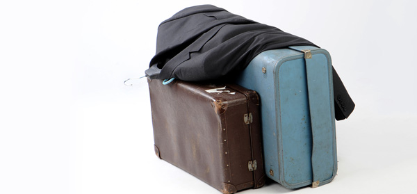 Suit jacket laying on suitcases for travel