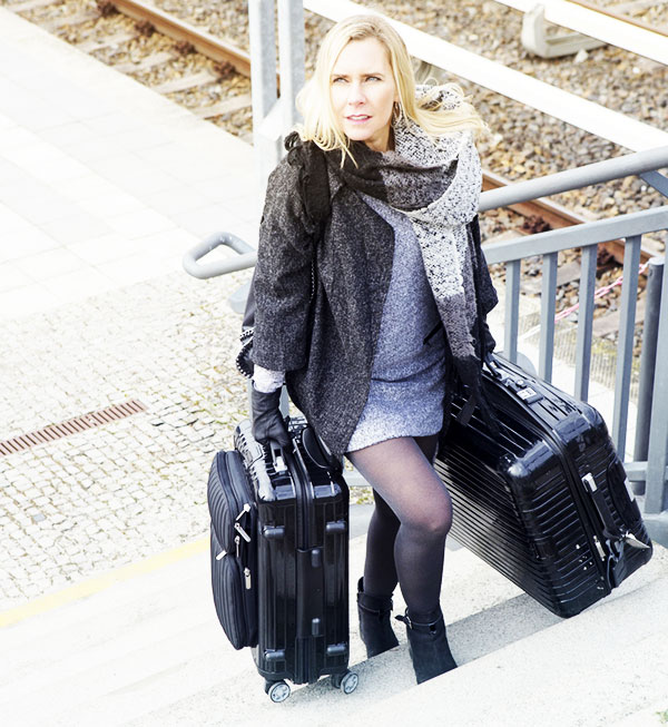 woman dragging big suitcases