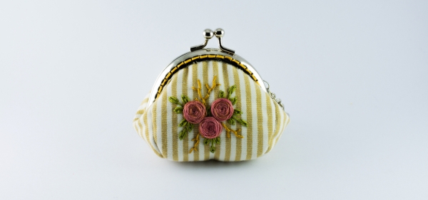 Woman's old coin purse on white background